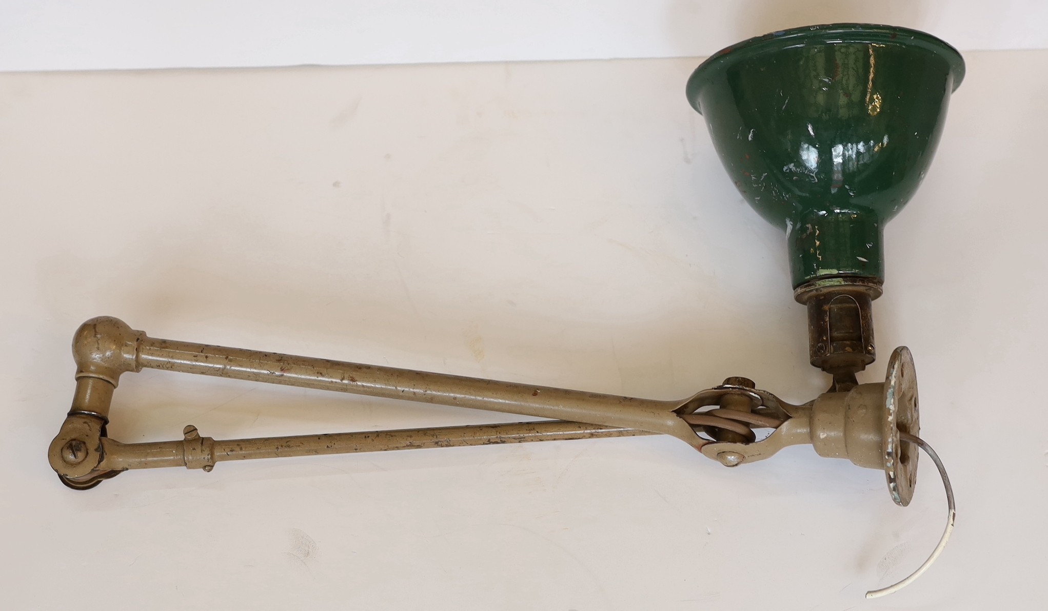 A 1920s Dugdill’s painted and enamelled metal adjustable work bench lamp, height 51cm at the bend